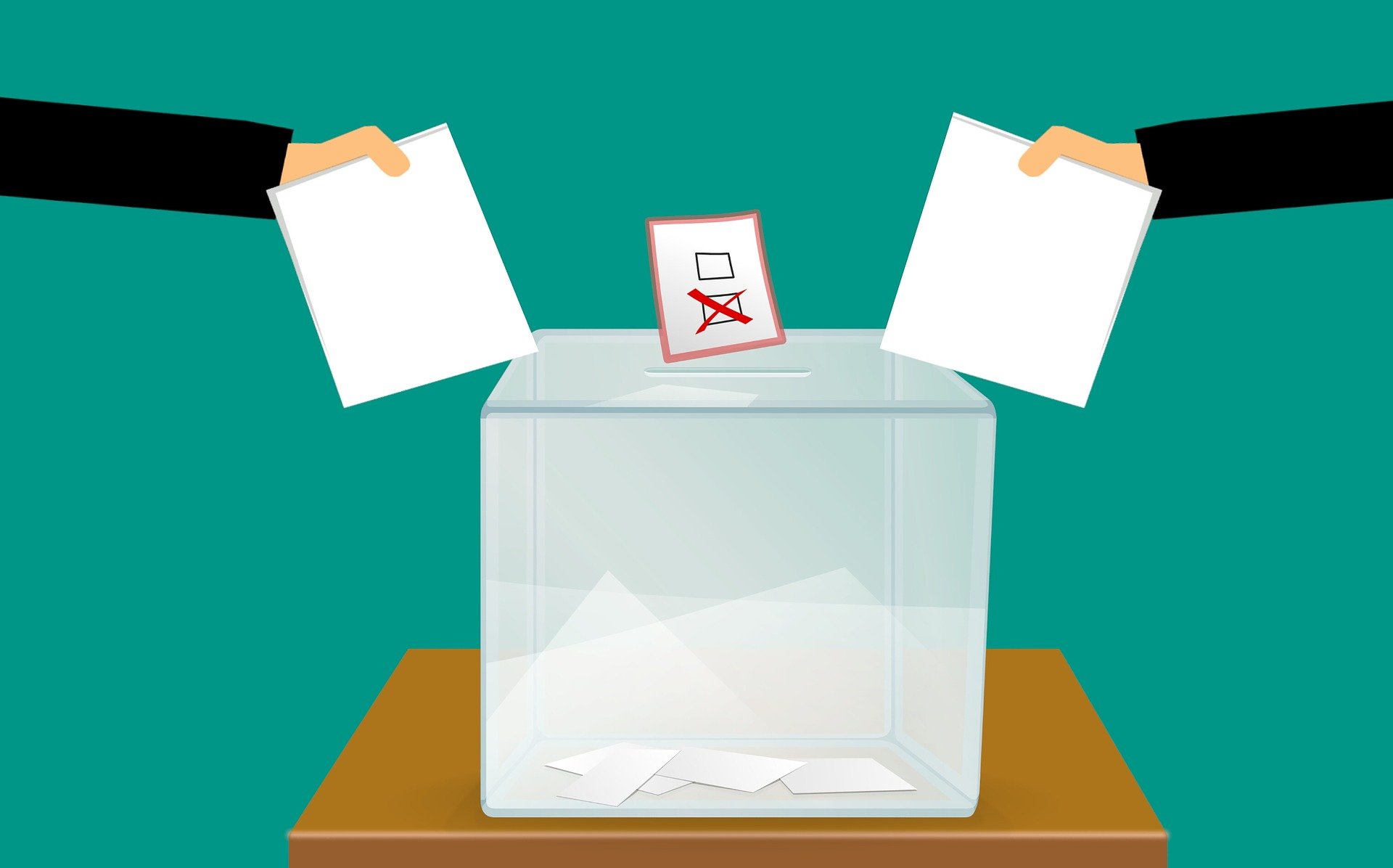 Two hands holding pieces of paper above a ballot box