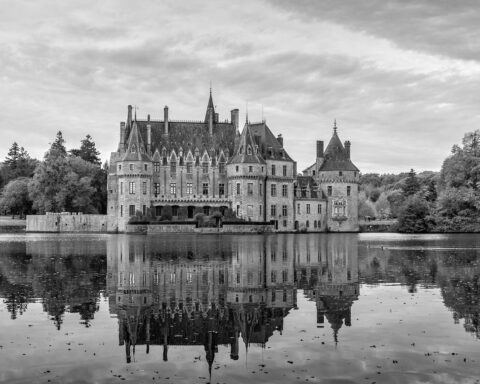 black-and-white castle behind a lake
